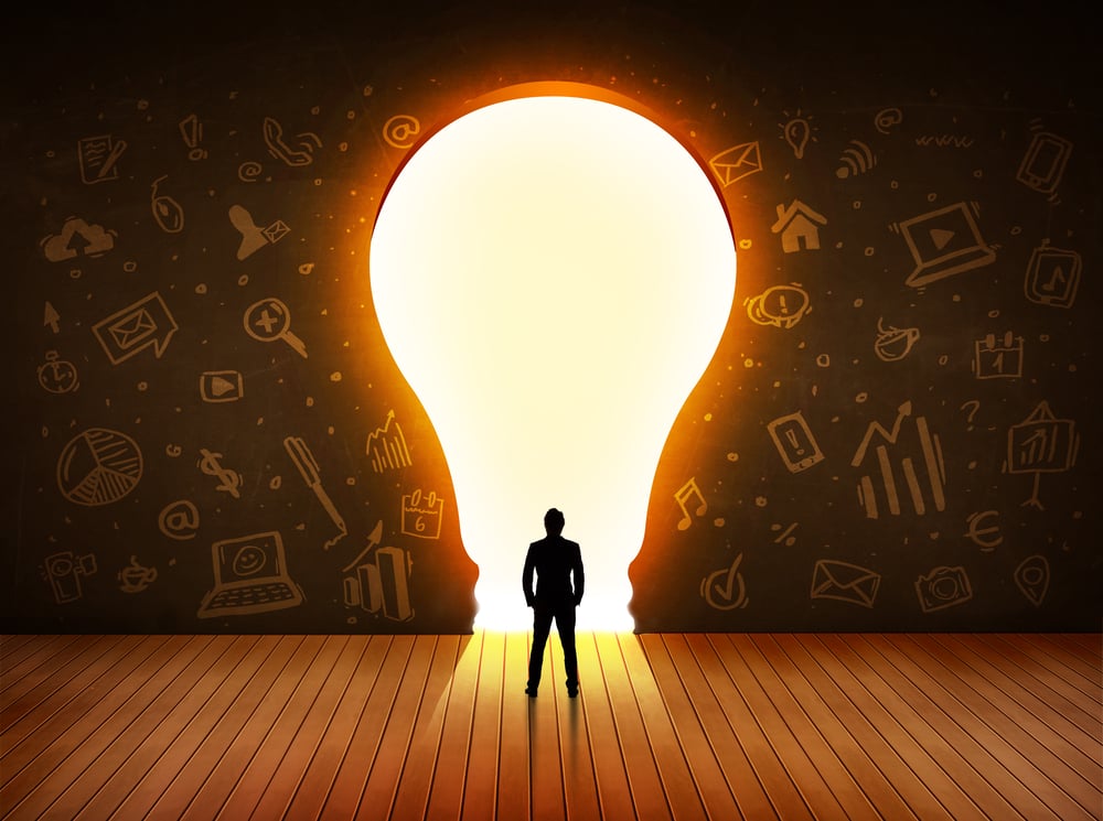 Business man looking at bright light bulb in the wall concept Business man looking at bright light bulb in the wall concept